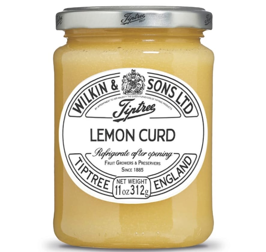A glass jar of Wilkin & Sons Ltd Tiptree Lemon Curd, featuring a white label with black text and a silver lid. Perfect for your favorite flower cookies recipe. The 312g (11oz) jar should be refrigerated after opening.